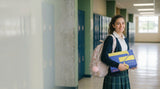 Teenage girl in a school uniform with a backpack and an Unbount box in her hands.